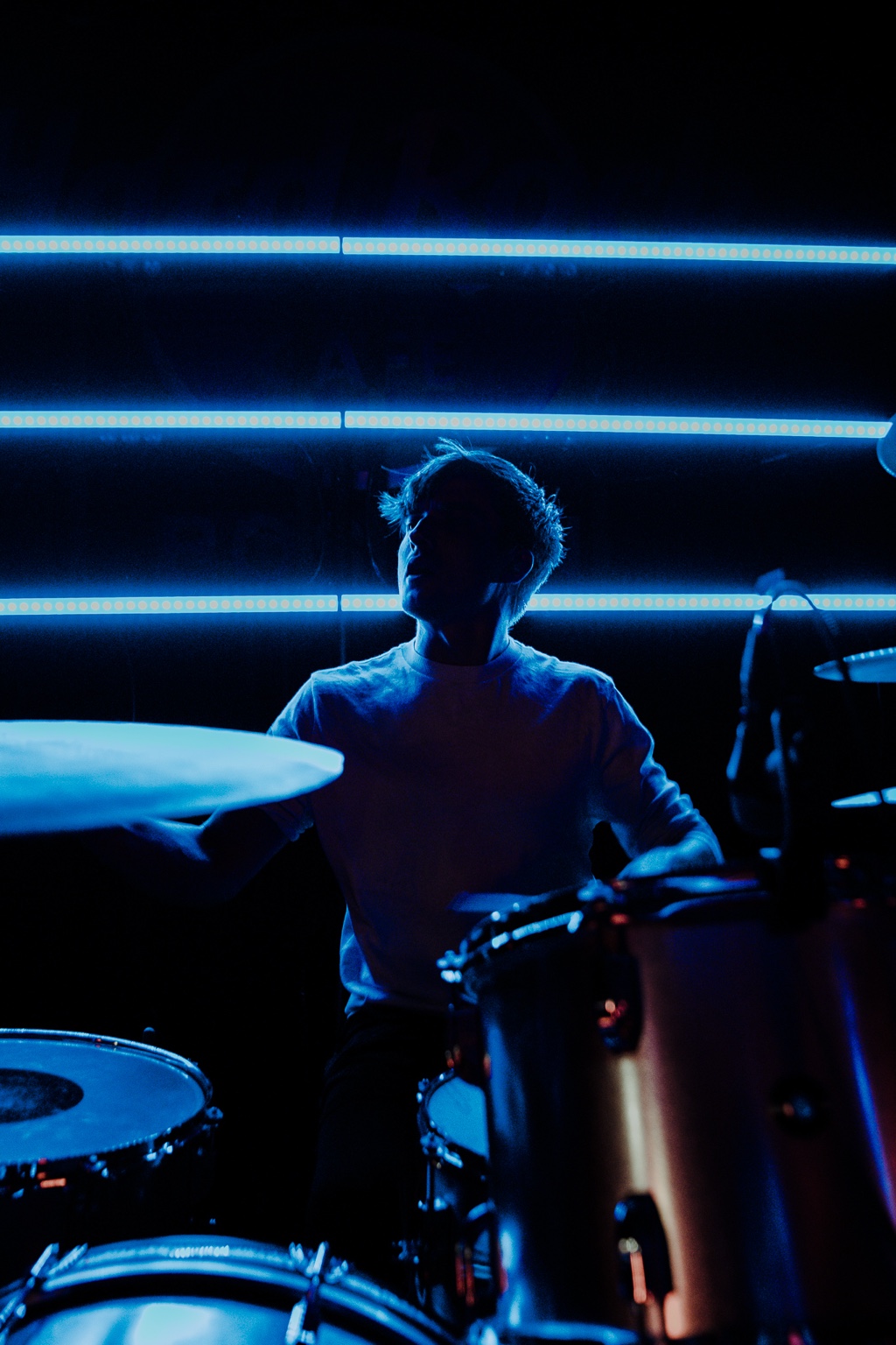 Vespera performing under blue stage lights