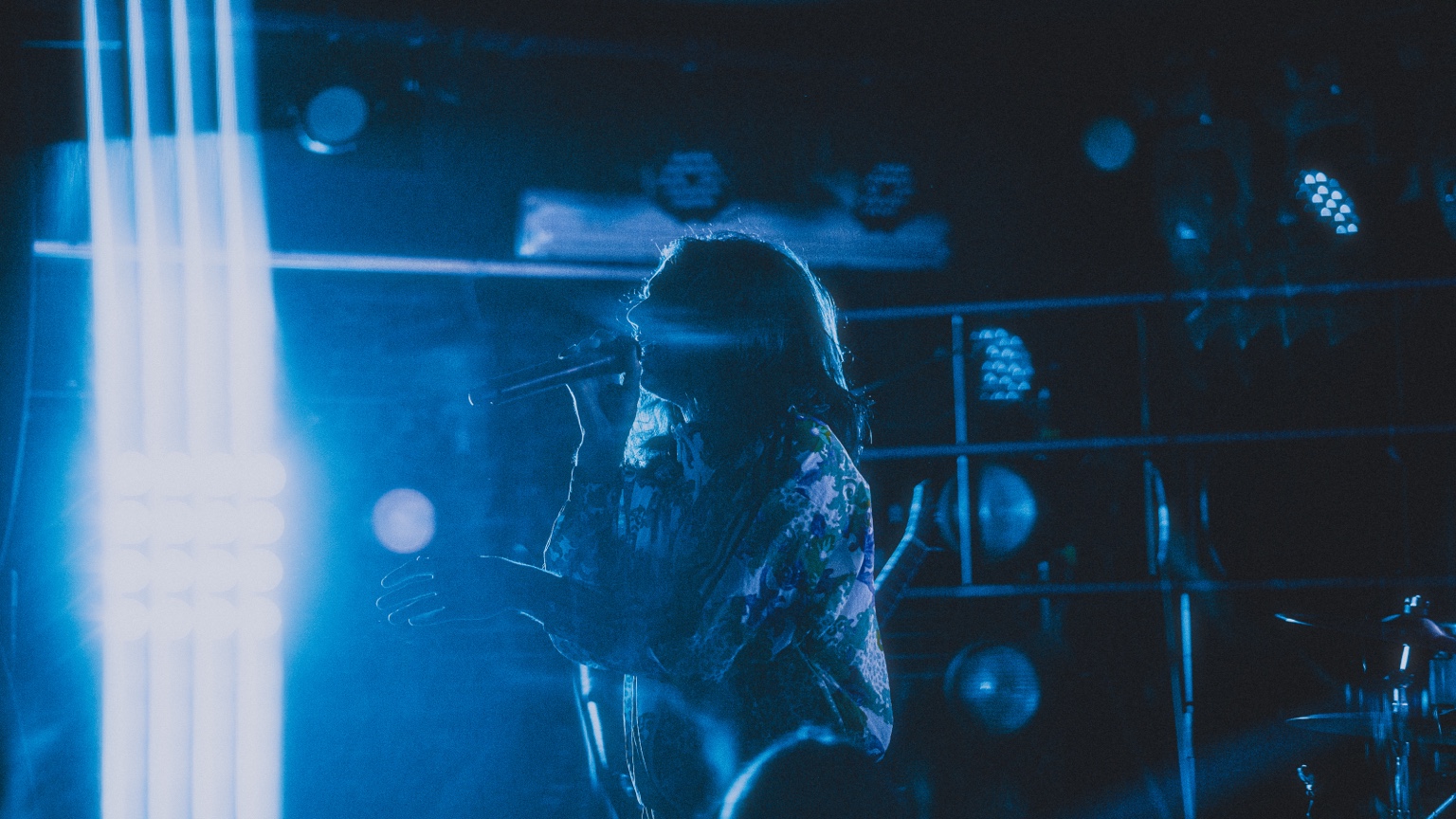 Casval Wolfe performing under blue stage lights